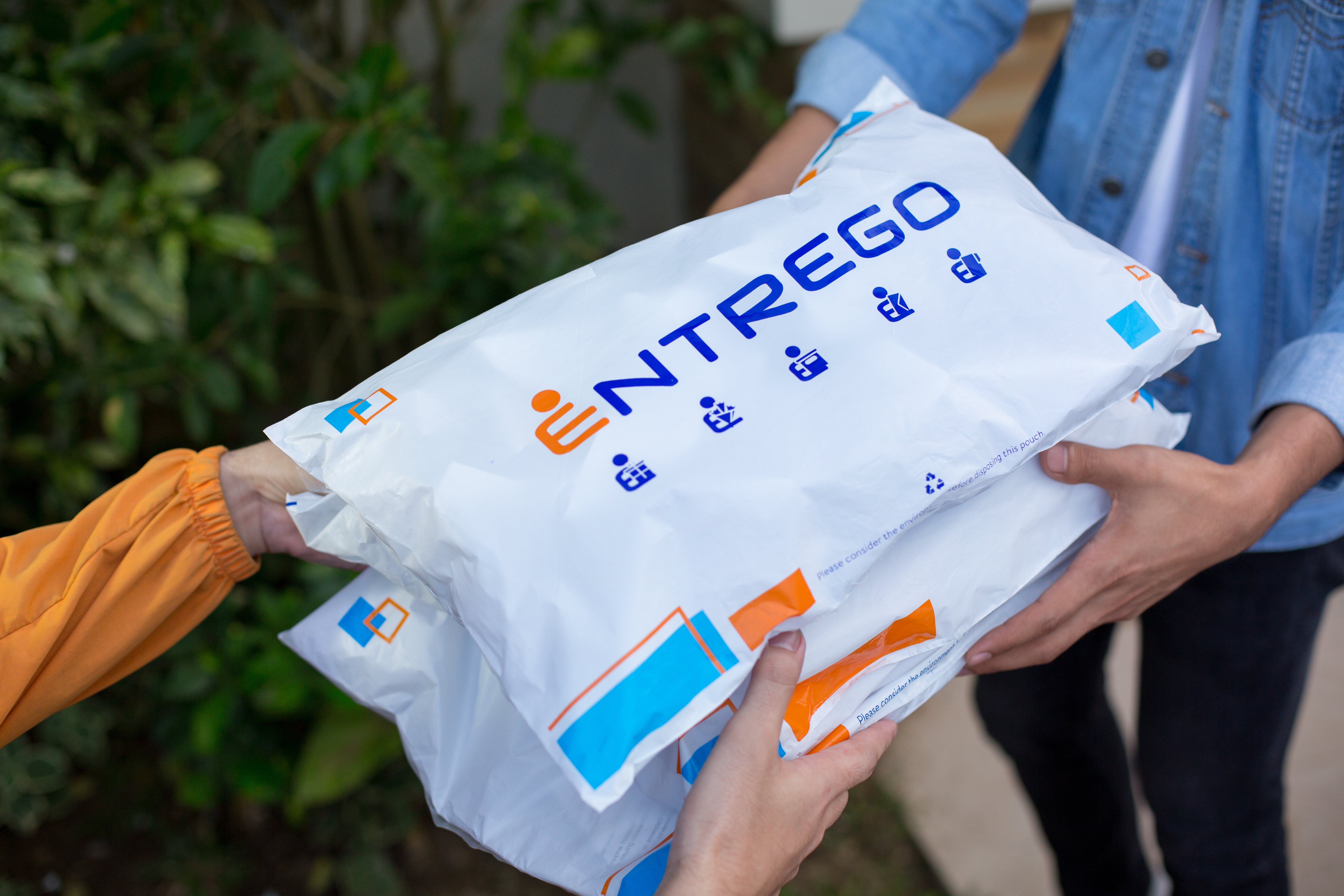 Rider handing Entrego parcel to recipient